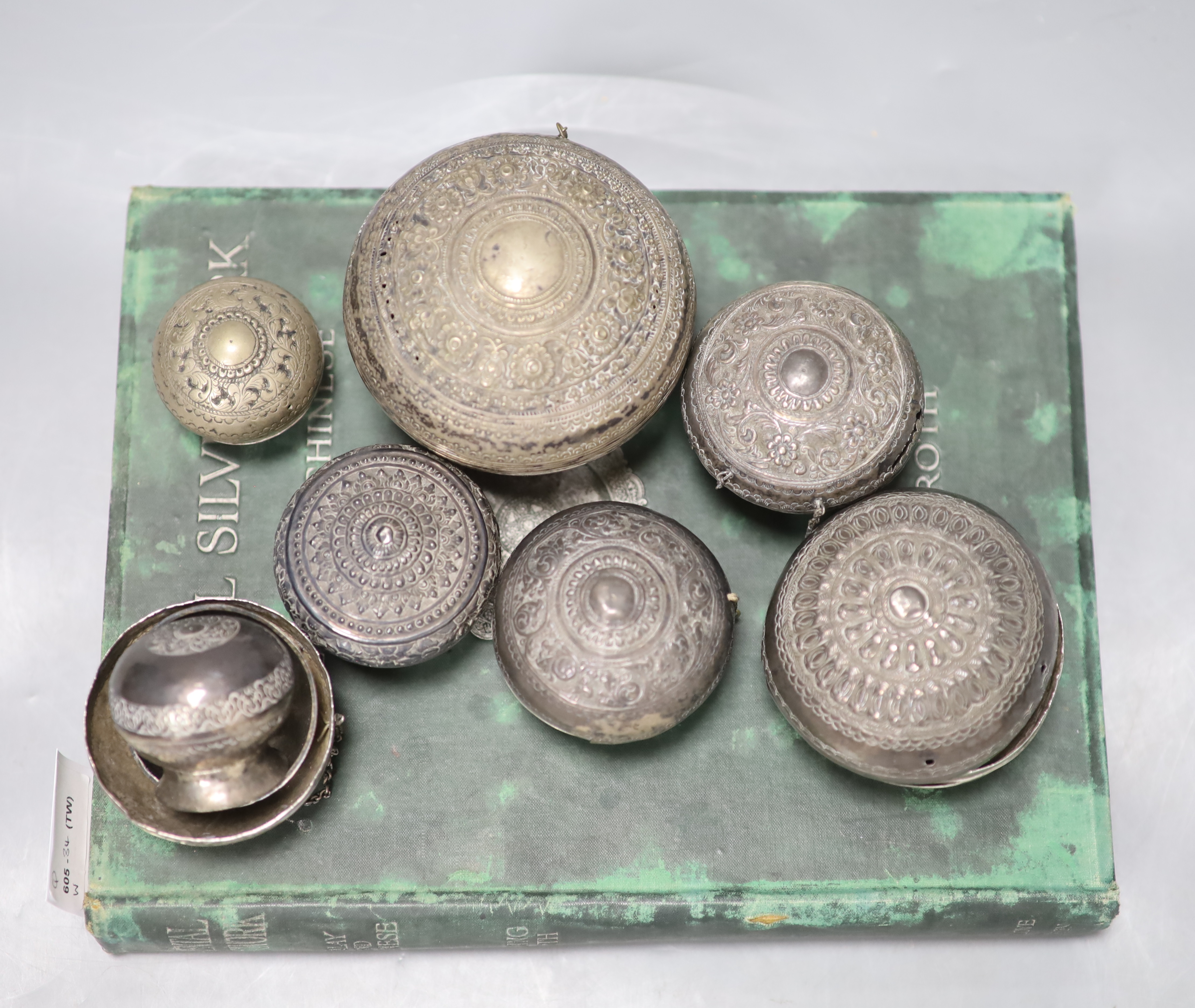 A collection of Malay Straits white metal circular betel nut boxes ('Chimbul'), Diameter 5cm to 10cm